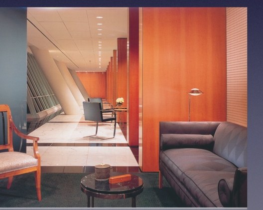 Warm wood-paneled corridor with lounge seating.