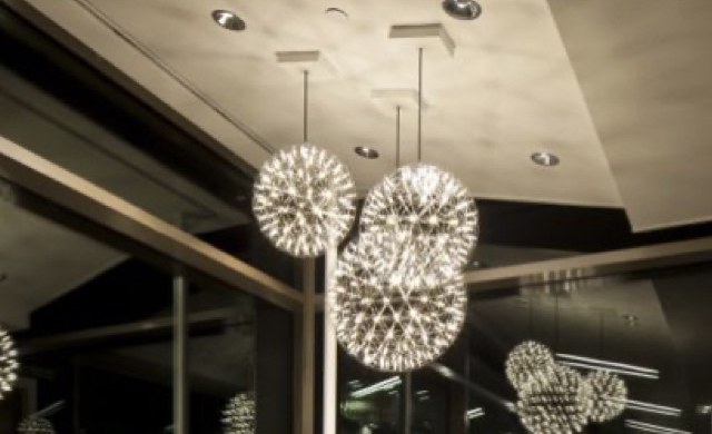 Sculptural pendant lighting over a lobby ceiling.